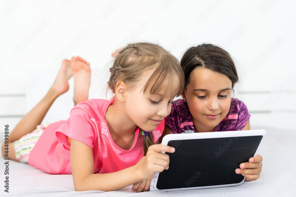 Little girls using tablet computer as art board - painting together Little girls using tablet computer as art board - painting together