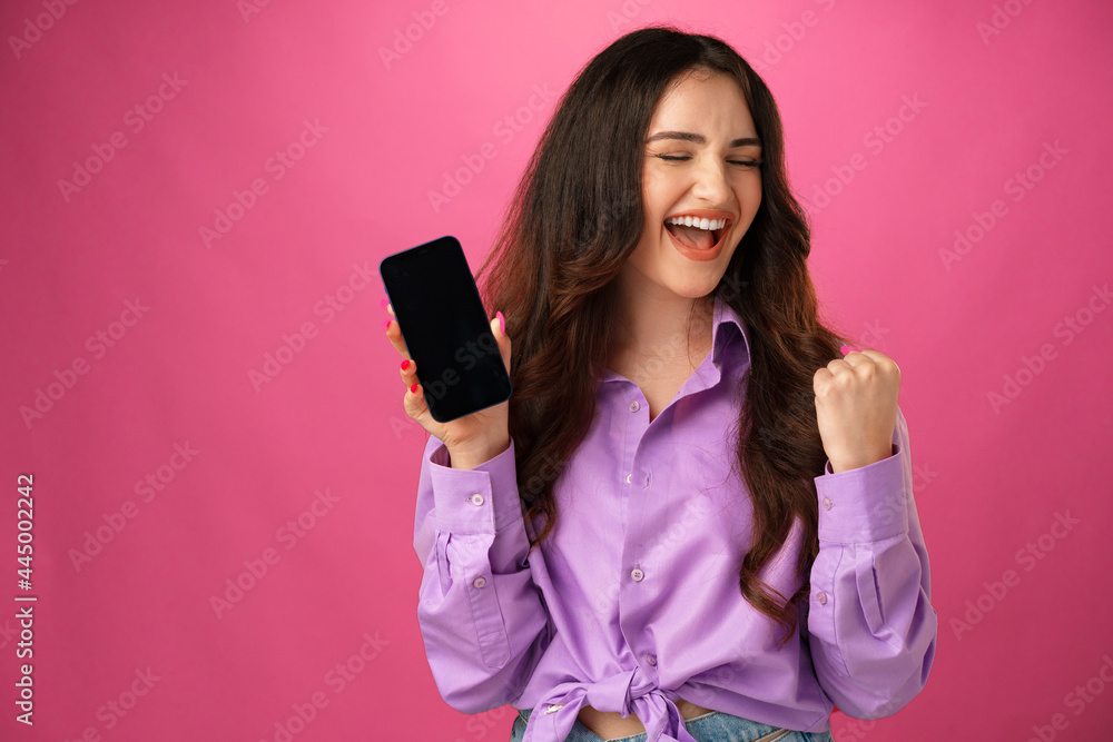 Attractive young woman showing blank smartphone screen with copy space Attractive young woman showing blank smartphone screen with copy space