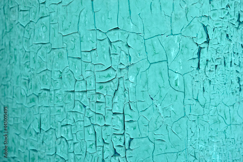 A blue old painted wall with peeling paint