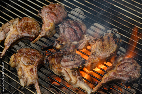 Lamb chops searing on a fiery grill during a holiday weekend celebration