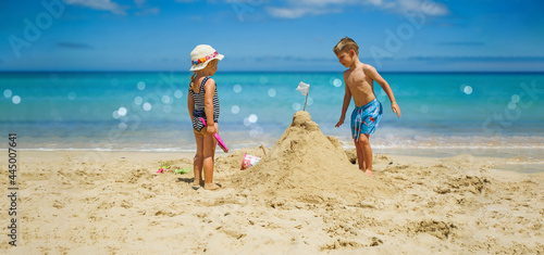 Canvas Print beach vacation in summer by the sea - kids playing at beach