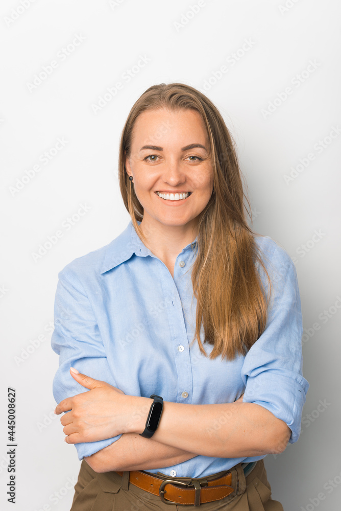 Smiling of business woman standing against white background with folded hands Smiling of business woman standing against white background with folded hands