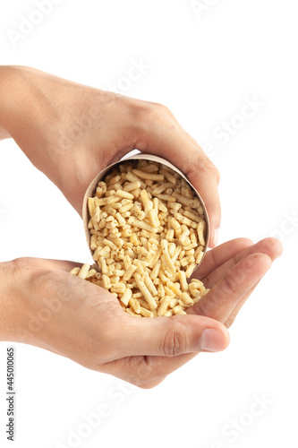 Close up of Ratlami Besan sev plane and salty Indian namkeen (snacks) In handmade ( handcraft ) brown paper cone bag in hand ready to eat