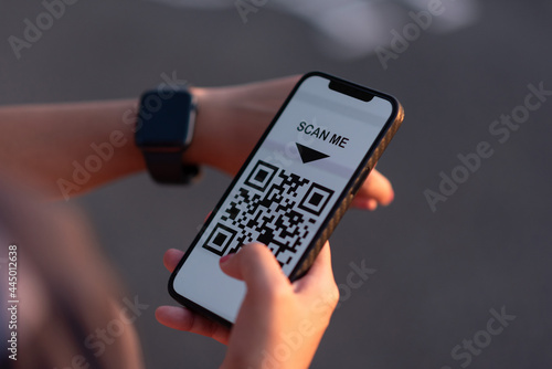 Wallpaper Mural girl's hand holding a smartphone to register about the covid 19 19 vaccine Torontodigital.ca