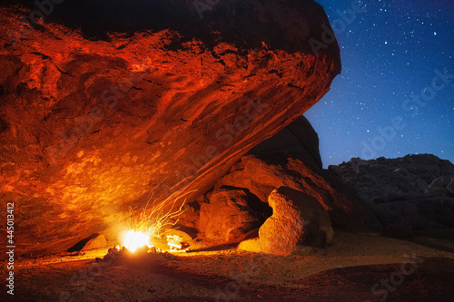 Camp Fire in Cave Under Stars at Night photo