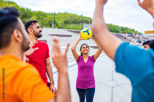 multiethnic team group playing beach volley on sun light