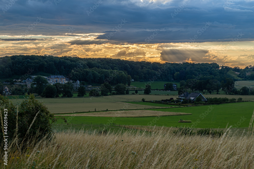 Long exposure image of an amazing sunset over the valley in Maastricht with a dramatic sky, showing amazing colors and impressive landscape views with on a view of Devils cave a former quarry