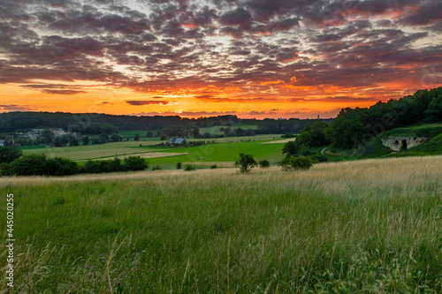 Long exposure image of an amazing sunset over the valley in Maastricht with a dramatic sky, showing amazing colors and impressive landscape views with on a view of Devils cave a former quarry © KimWillems