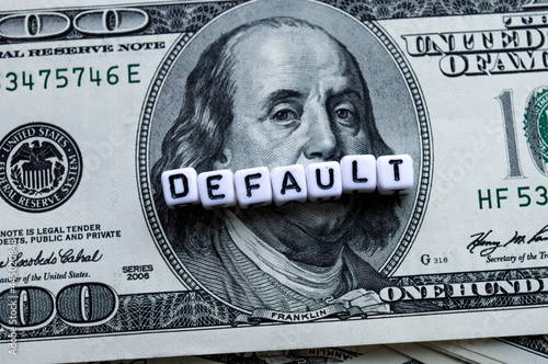 One hundred US dollars banknotes. Default word in cubes. Bankruptcy. Cash one hundred dollar bills, 100 dollars, Benjamin Franklin portrait, american currency exchange finance.