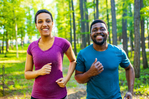 Fit young african american couple in sport activity outdoors runs in morning