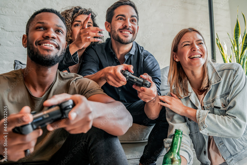 Group of friends playing video games together. Stock Photo Adobe