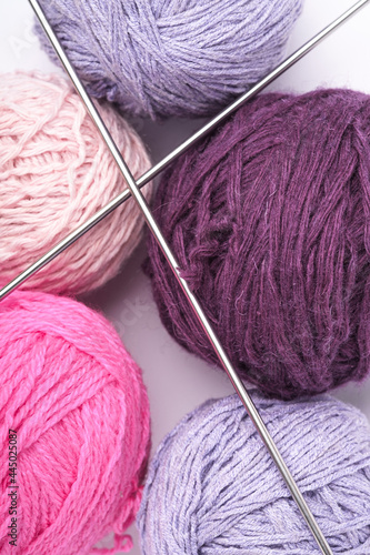 Colorful yarn balls and knitting needles close up