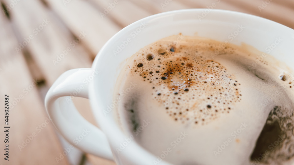 Close up of coffee cup on balcony table Close up of coffee cup on balcony table
