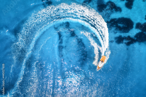 Slika na platnu Aerial view of the speed boat in clear blue water at sunny day in summer