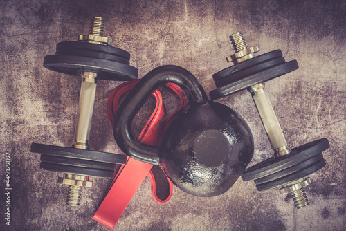 dummbells and kettlebell on vintage background photo