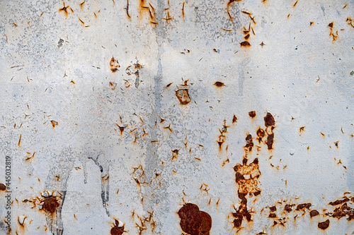 Rusty metal texture. Peeling paint on the rust wall. © andyborodaty