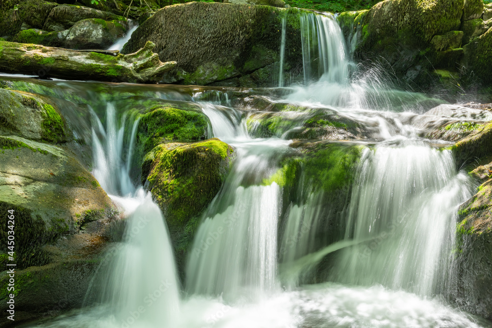Long exposure of a waterfall on the Hoar Oak Water river at Watersmeet in Exmoor National Park Long exposure of a waterfall on the Hoar Oak Water river at Watersmeet in Exmoor National Park