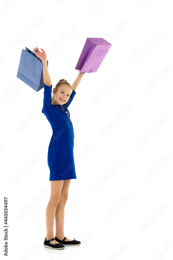 Little girl with multi-colored bags in their hands. Little girl with multi-colored bags in their hands.