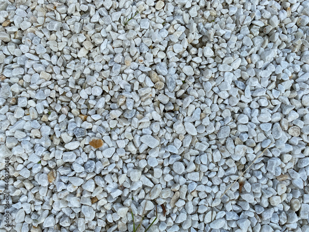 White texture from small sharp natural decorative stones. The background White texture from small sharp natural decorative stones. The background