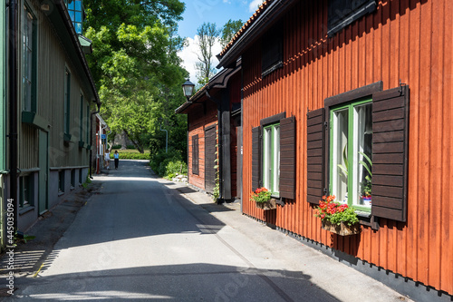The central walking street of the city of Sigtuna. Old wooden buildings built at the past centuries. Landmarks of the ancient capital of Sweden. Colorful painted wooden houses along the narrow street.