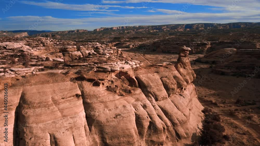 Flying over rock formations in a remote desert landscape Flying over rock formations in a remote desert landscape