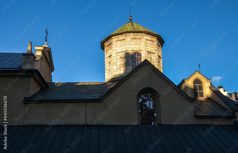 Domes and facade with christian cross on the tower of Ancient Armenian church of the Assumption of Mary in Lviv, Ukraine