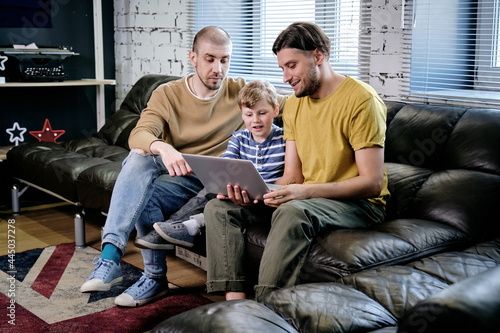 Two Men and Boy Watching Cartoon photo