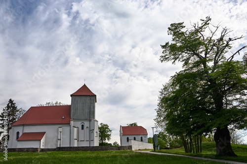A rural Catholic church with a wooden belfry