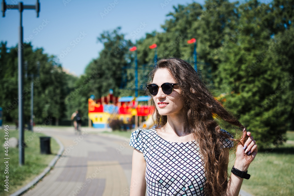A beautiful Russian girl walks in the city park A beautiful Russian girl walks in the city park