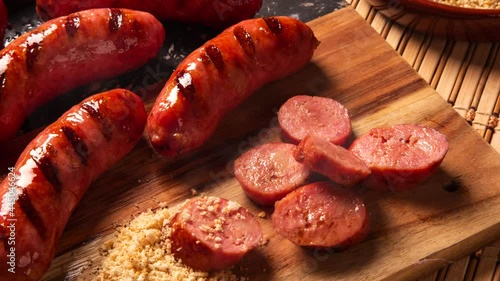 Grilled sausage with smoke. Grilled Sausage on wooden board. Brazilian barbecue.