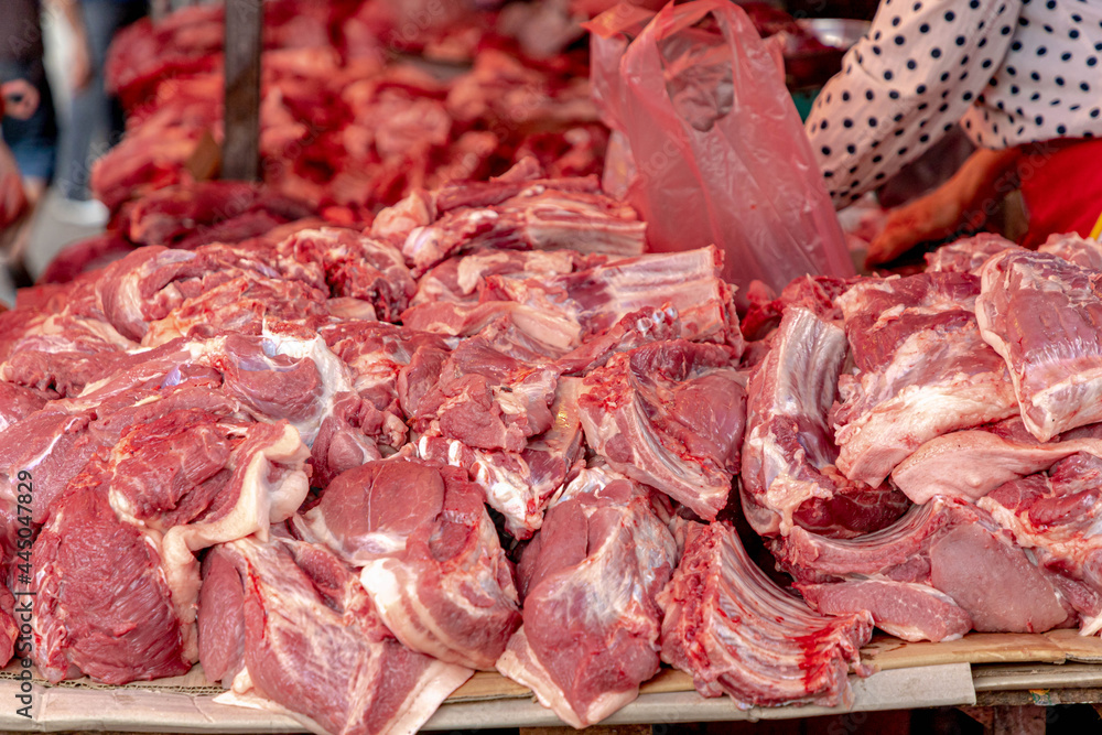 Raw pork meat with red bloody from fresh open air market in Thailand, Pile of chopped pork meat on stall.