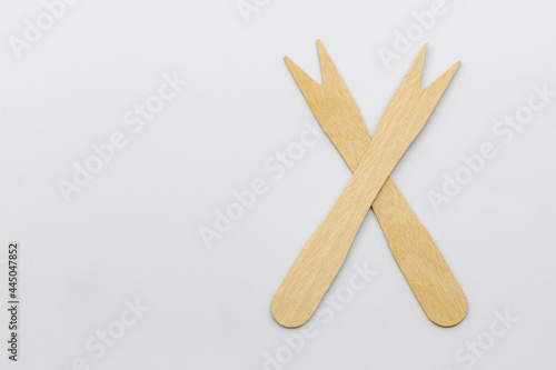 Selective focus of wooden cocktail fork on white background, Two small wood spike fork toothpick, A new alternative cutlery that can decompose naturally, Eco friendly products.