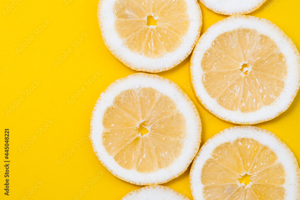 slices of fresh yellow lemon on yellow background slices of fresh yellow lemon on yellow background
