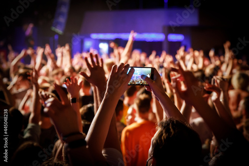 Using a mobile phone at the concert.