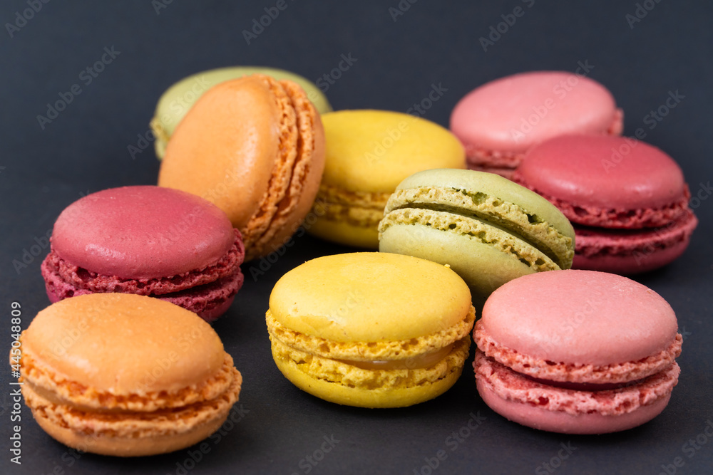 Macarons on dark background, colourful french cookies macarons. Macarons on dark background, colourful french cookies macarons.