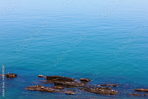 a view of the blue sea with rocks