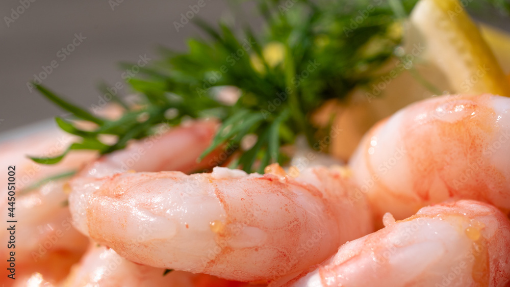 Fantastic close up of peeled fresh shrimps on white bread, making a delicious Swedish shrimp sandwich (räkmacka) complete.
Seafood and food preparation concept.