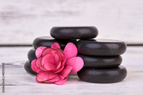 Close-up rose flower head and polished stones for spa.
