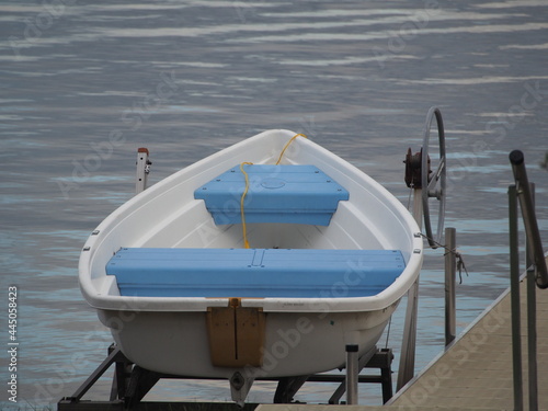 White Rowboat with Blue Seats on Boat Lift - Lake Life