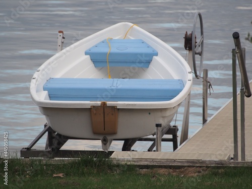 White Rowboat with Blue Seats on Boat Lift - Lake Life