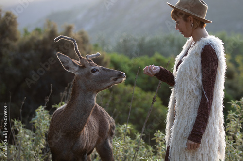 Photography Young beautiful elegant woman with a deer in a forest