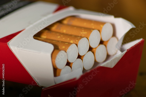 Close-up photographed open brown filter cigarette box as a threat to people's health