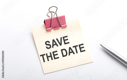 Save the date text on sticker with pen on the white background