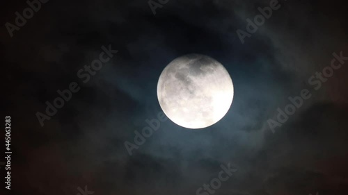 Clouds drifting across the sky. Full moon in the background