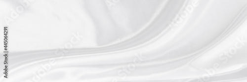 White gray satin texture that is white silver fabric silk panorama background with beautiful soft blur pattern natural.