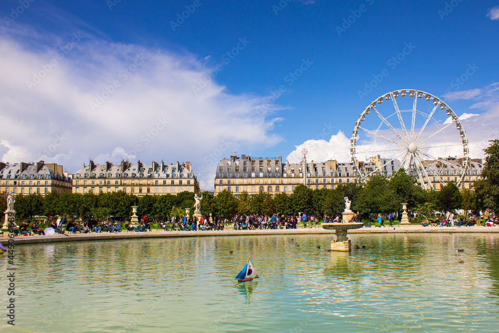Fototapeta premium Scenic view of pond at Tuileries garden with Ferris wheel in background. Place de la Concorde Paris