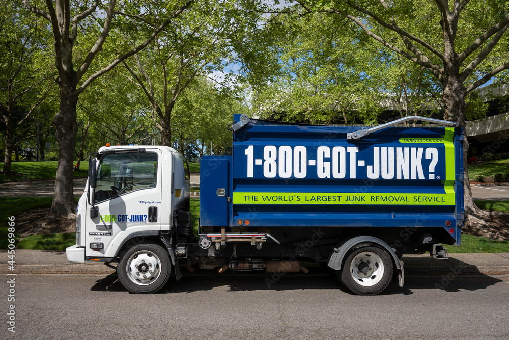 Tigard, OR, USA May 2, 2021 A 1800GOTJUNK garbage truck is seen