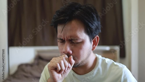 asian man with sore throat and cough sneeze