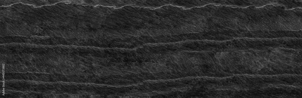 Fototapeta premium Panorama dark gray stone background with copy space. Black grunge banner with rock texture.