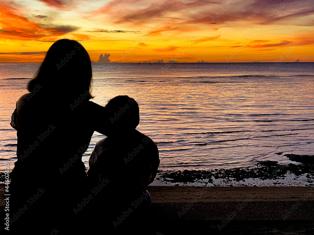 silhouette of family watching sunset at the beach in Hua Hin